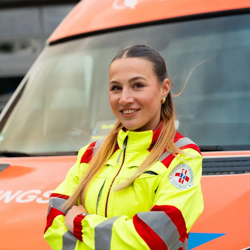 Woman standing in front of an ambulance